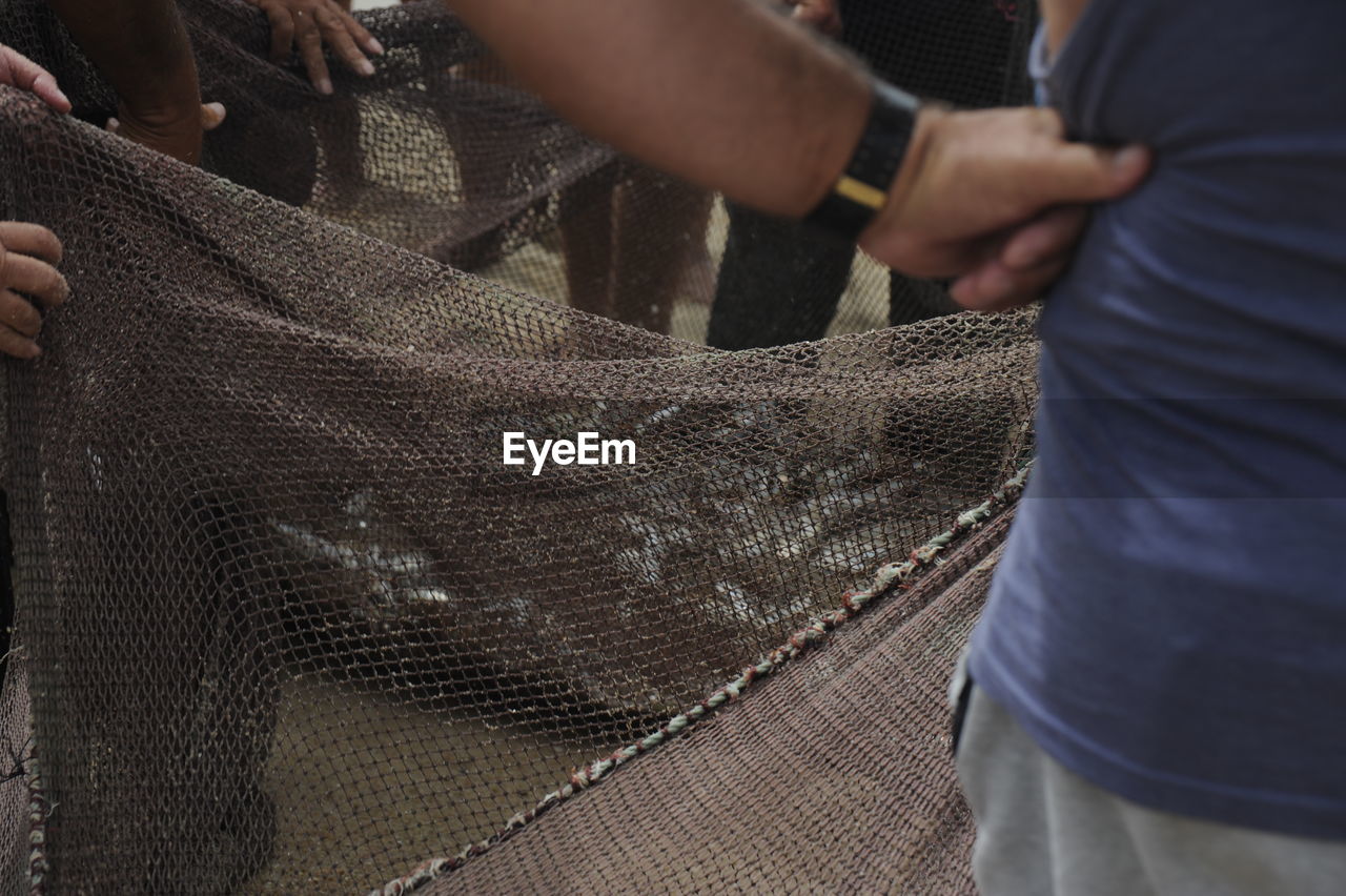 Fishermen holding fishing net