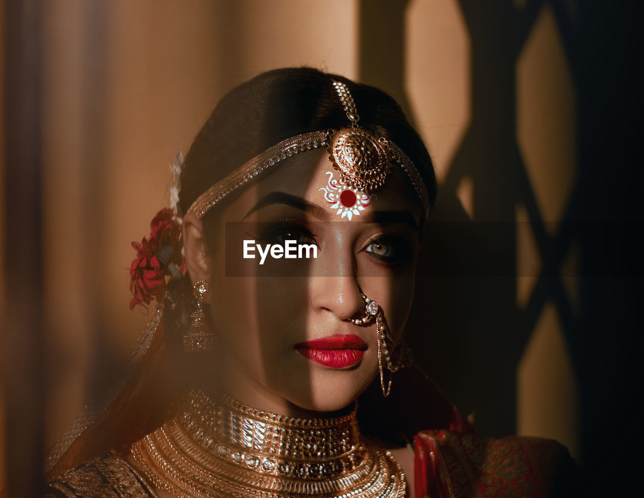 Portrait of beautiful bride against wall