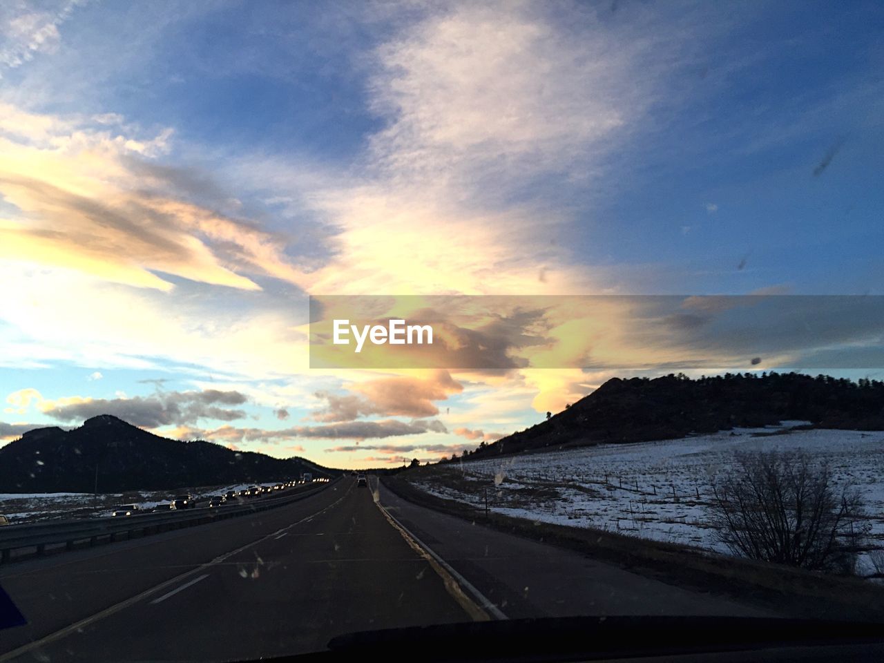 Empty road along snowed landscape