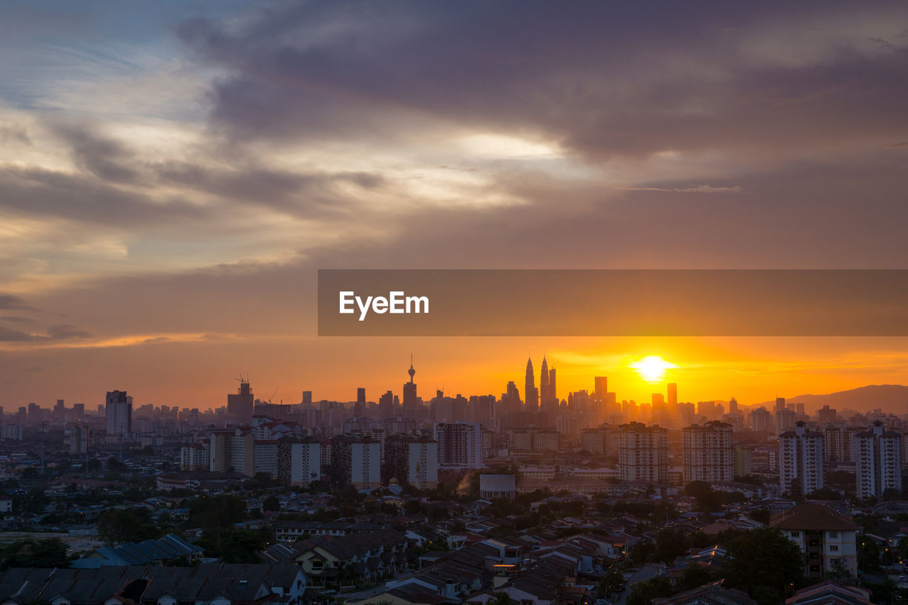 Cityscape against sky during sunset