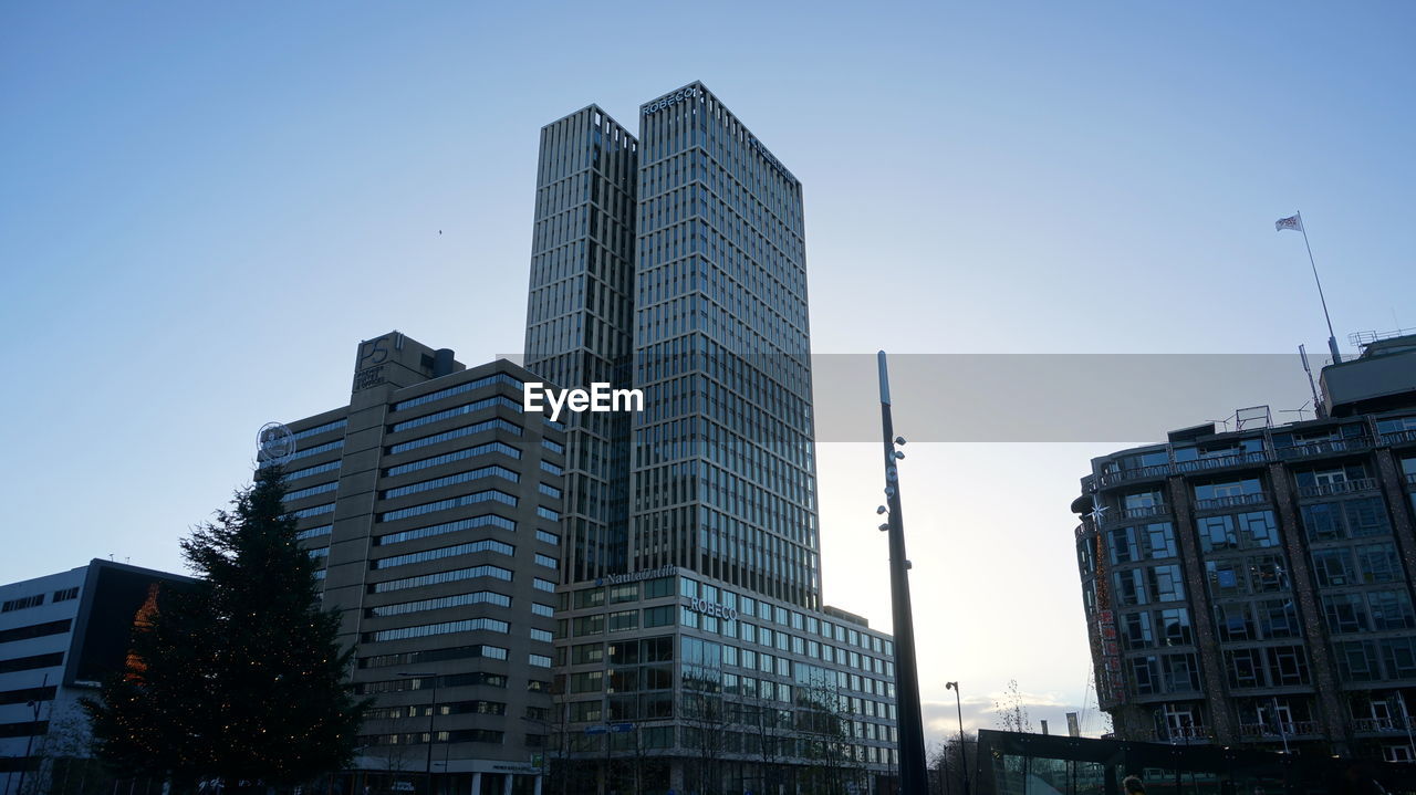 Low angle view of modern buildings against clear sky