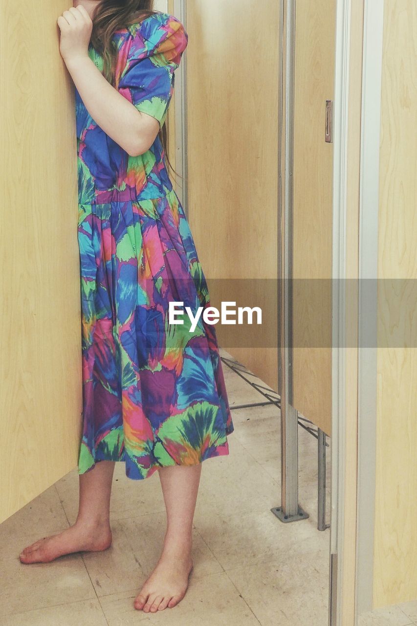 Woman wearing dress in fitting room