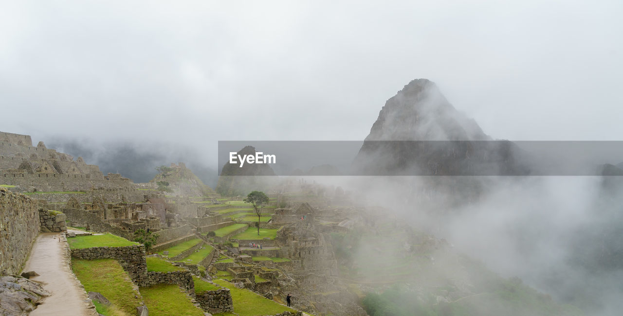 Rocky mountains at machu picchu during foggy weather