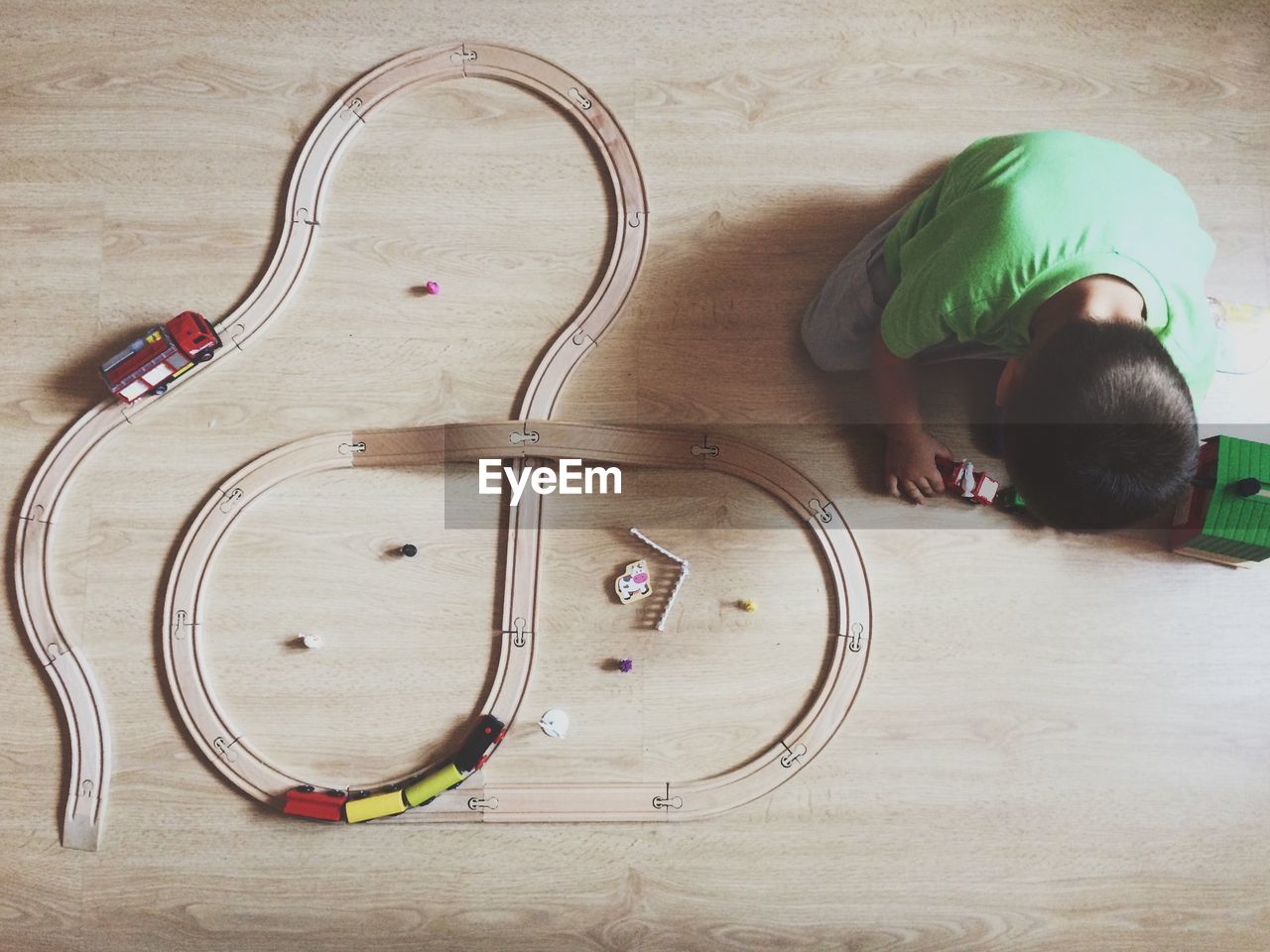 High angle view of boy playing with toy train at home