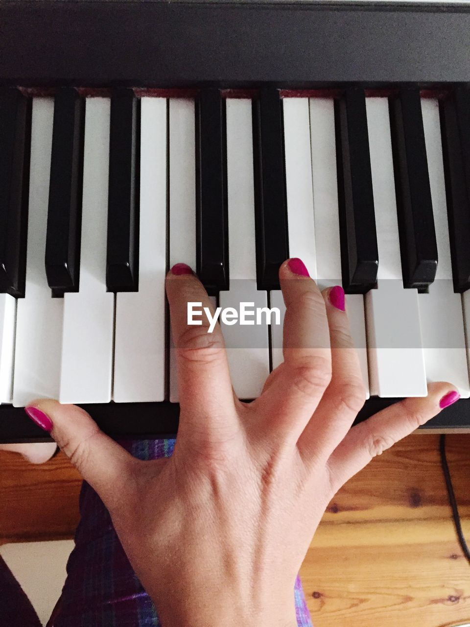 Cropped image of woman hand playing piano