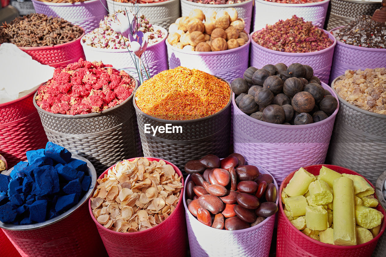 Colorful boxes with dried spices, tea and incense at bazaar market in dubai filling the frame