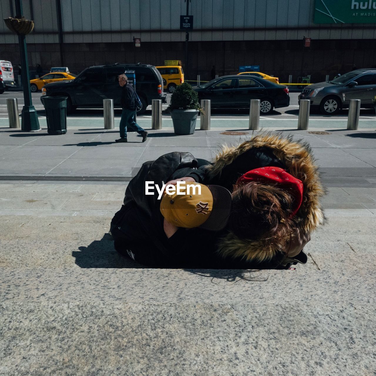 PEOPLE LYING ON STREET