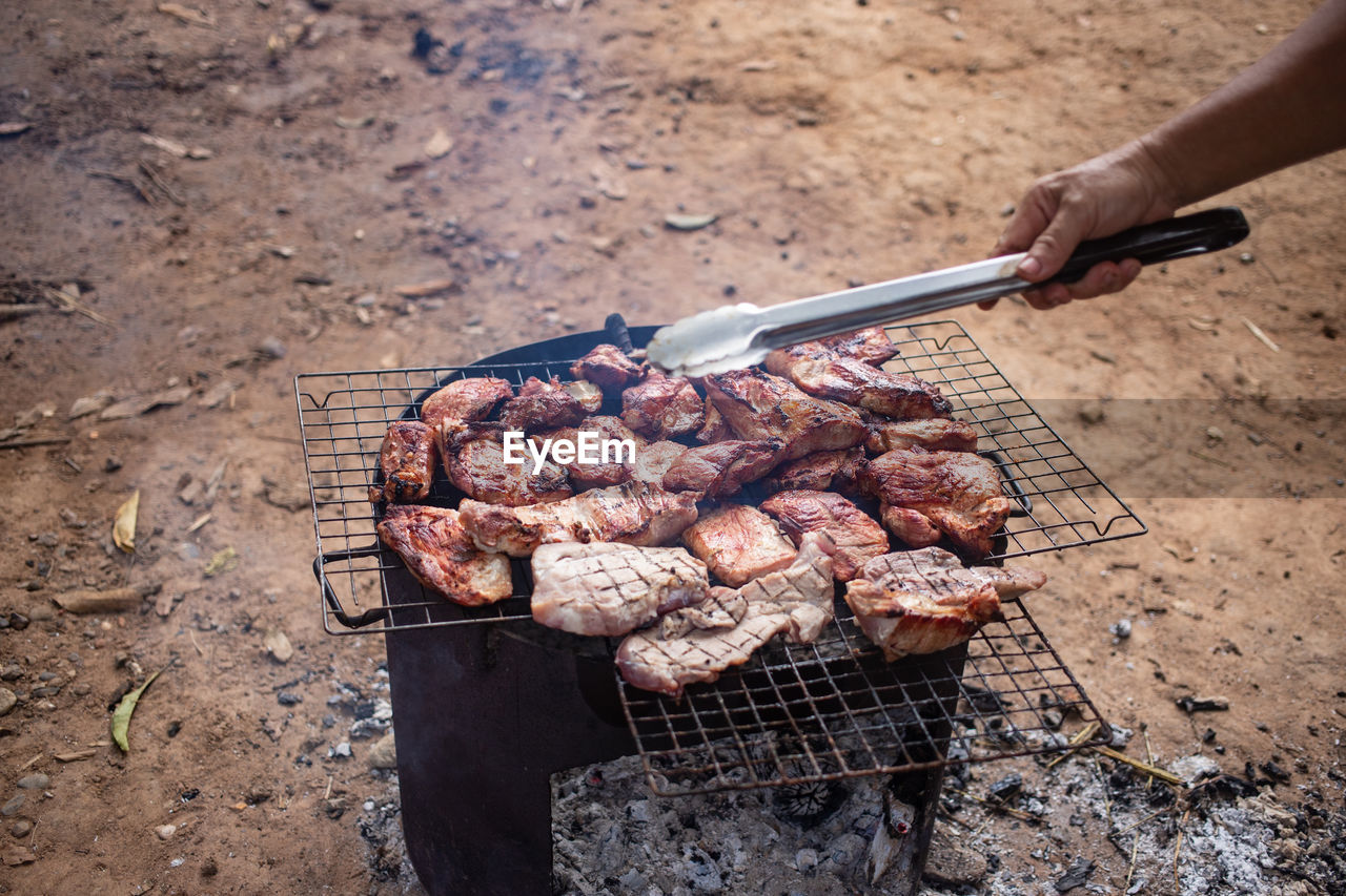 HIGH ANGLE VIEW OF MEAT COOKING ON BARBECUE