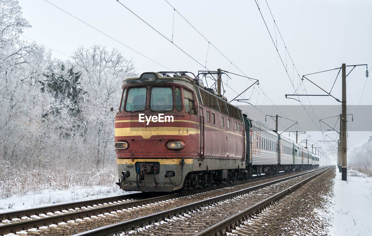 TRAIN ON RAILROAD TRACK IN WINTER