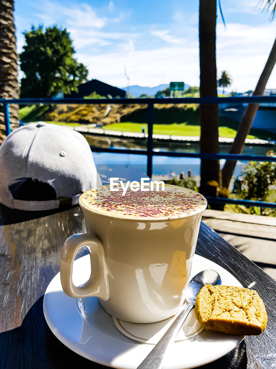 CLOSE-UP OF COFFEE CUP ON TABLE AT CAFE