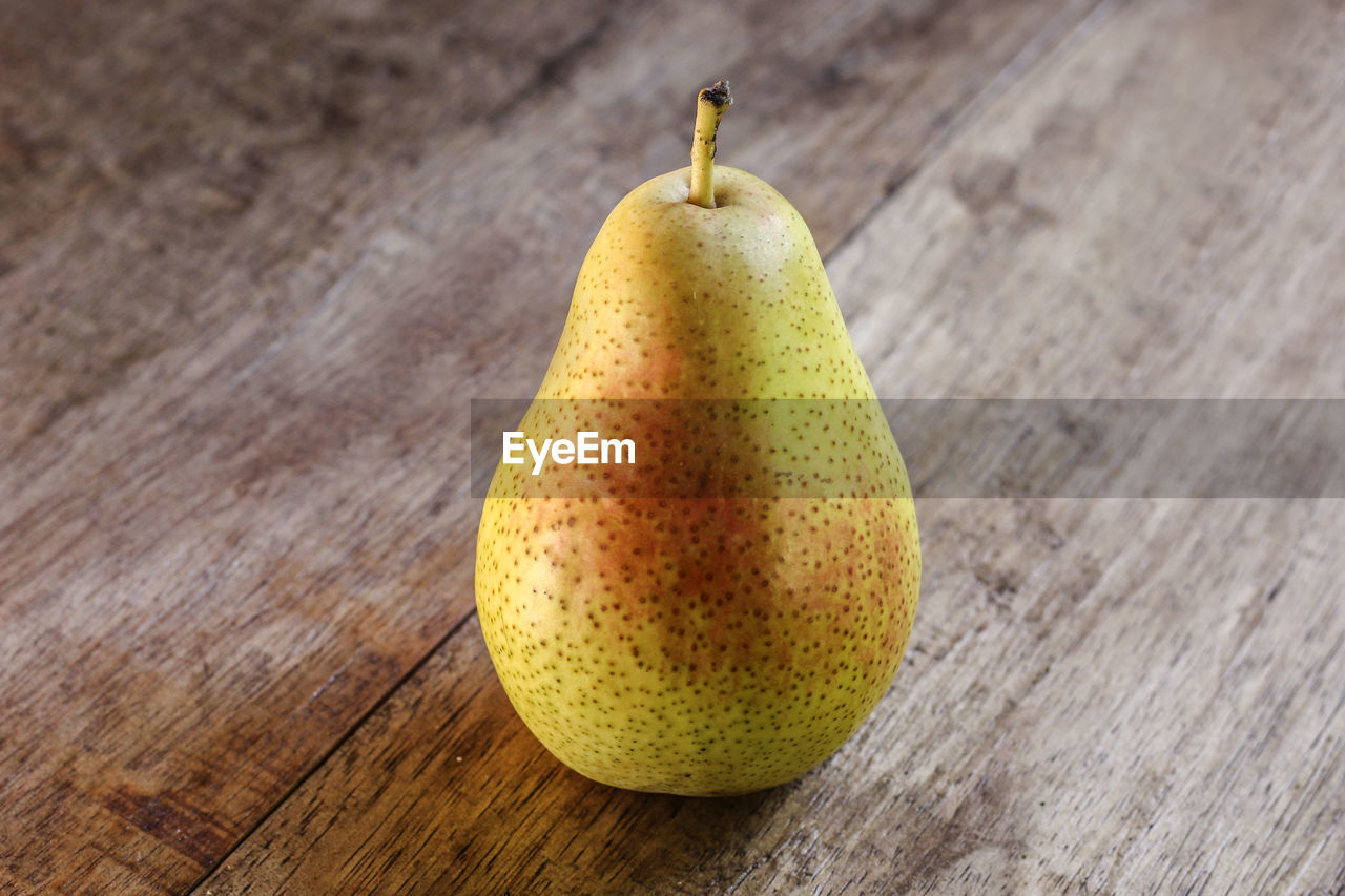 Close-up of pear on wooden table