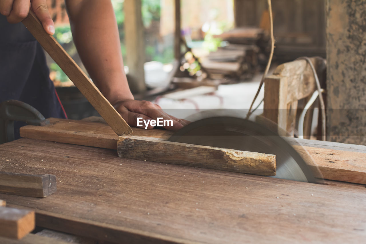 cropped hands of man working on table