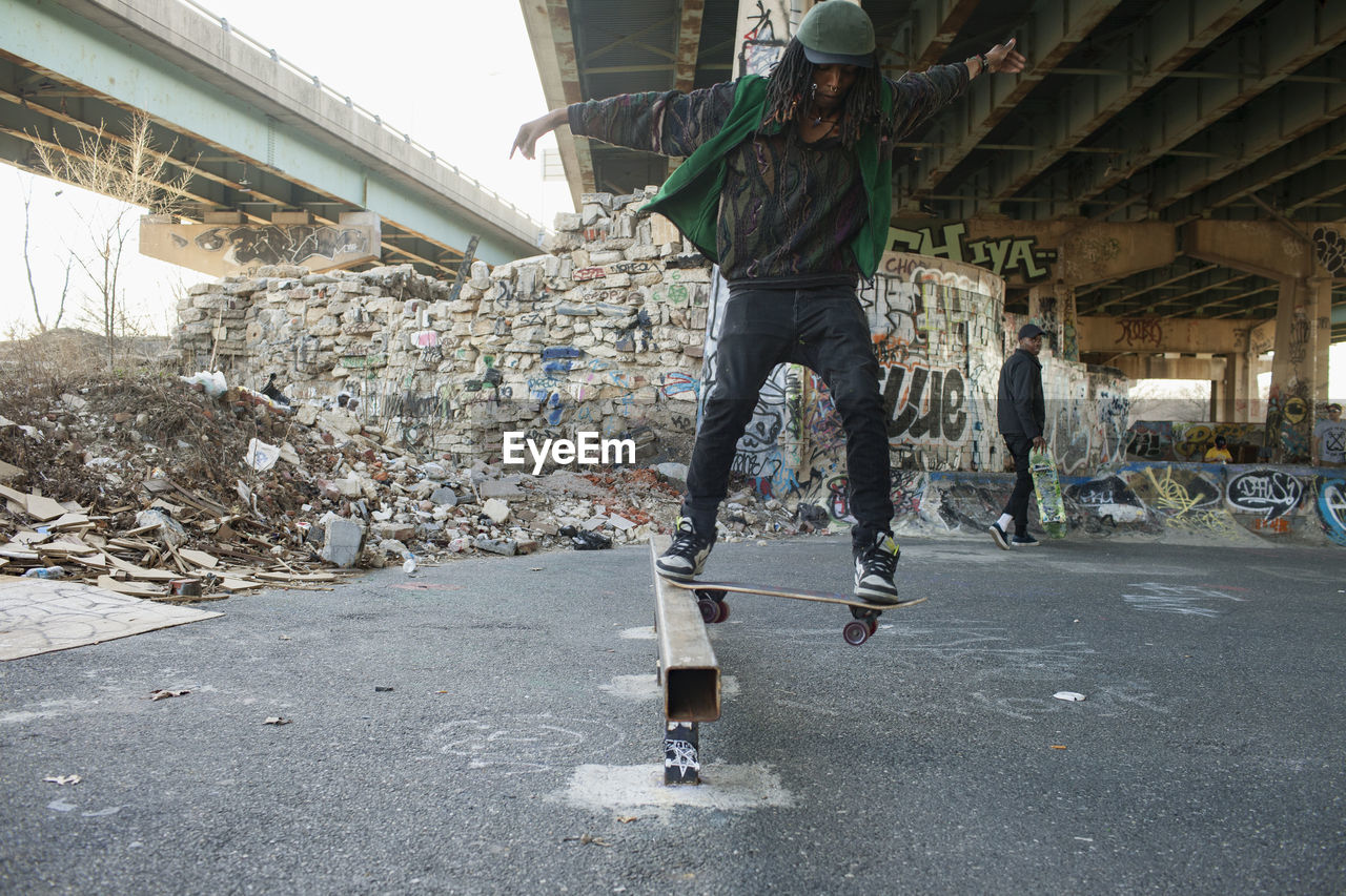 A young man skateboarding.