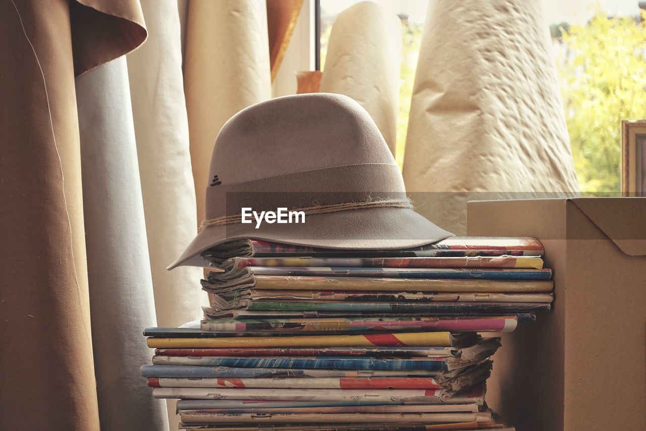 Close-up of hat on stacked book