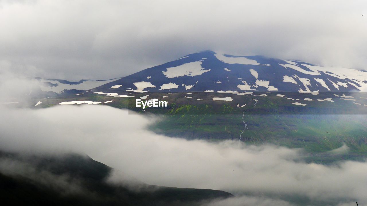 Snow on mountain at early foggy morning