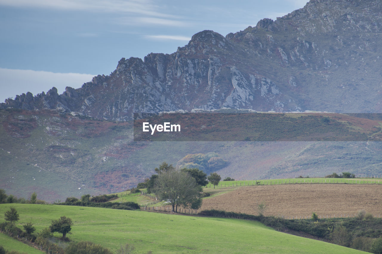 Scenic view of landscape and mountains against sky