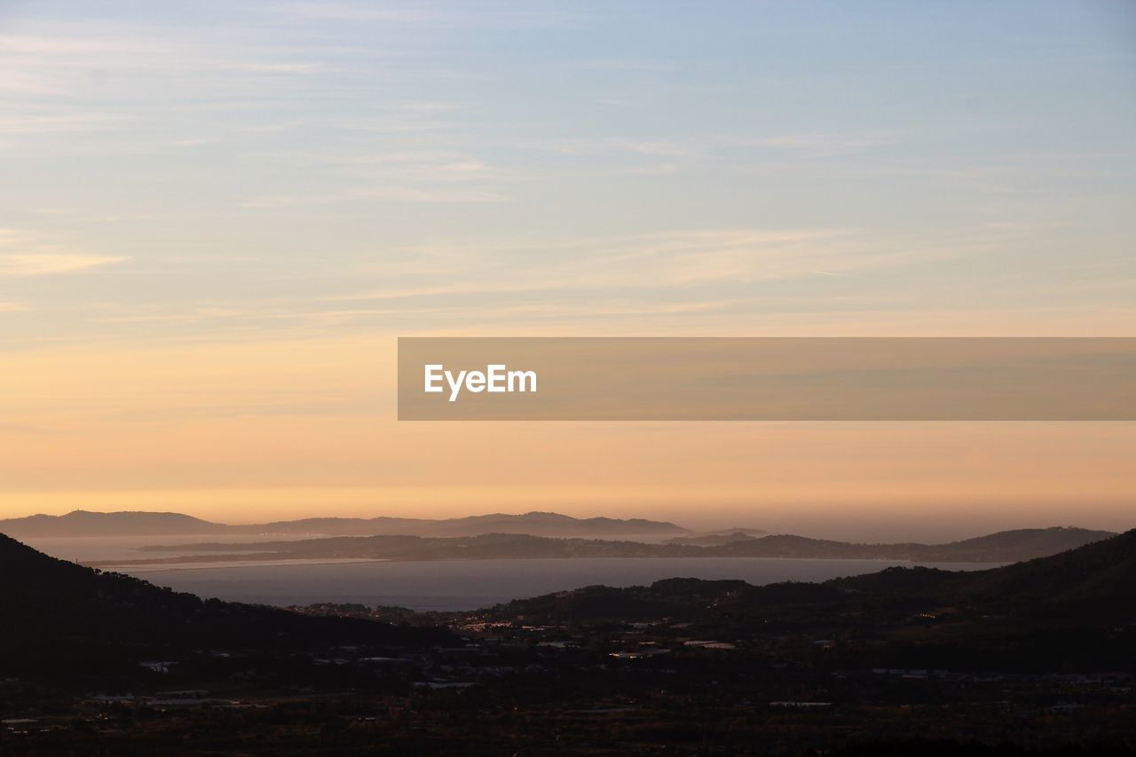 Scenic view of silhouette mountains against sky during sunset