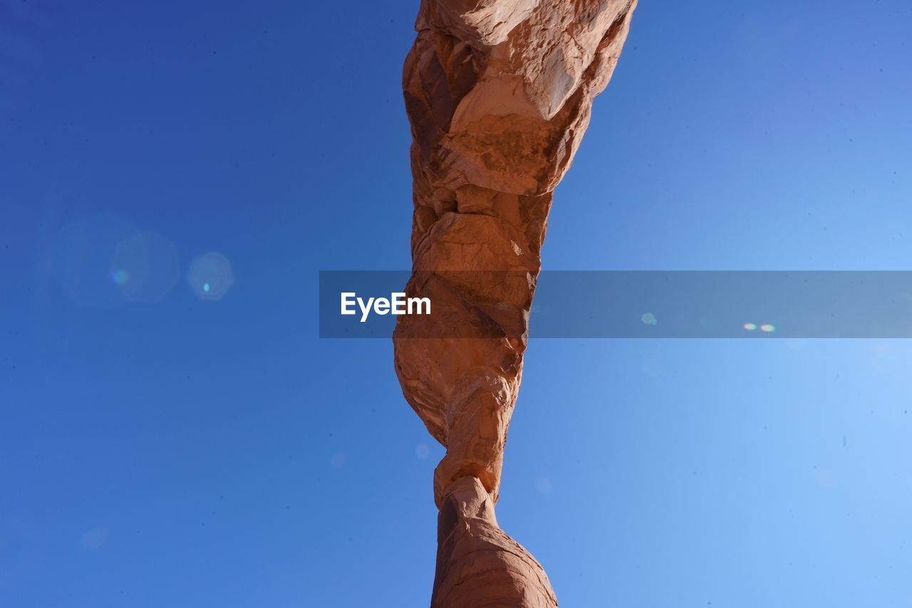 Low angle view of delicate arch against clear sky