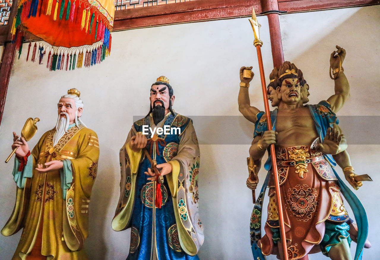 PANORAMIC VIEW OF STATUES IN TRADITIONAL CLOTHING