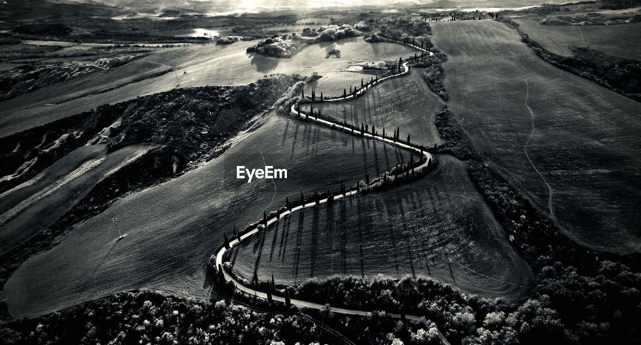 HIGH ANGLE VIEW OF ROAD BY AGRICULTURAL LANDSCAPE