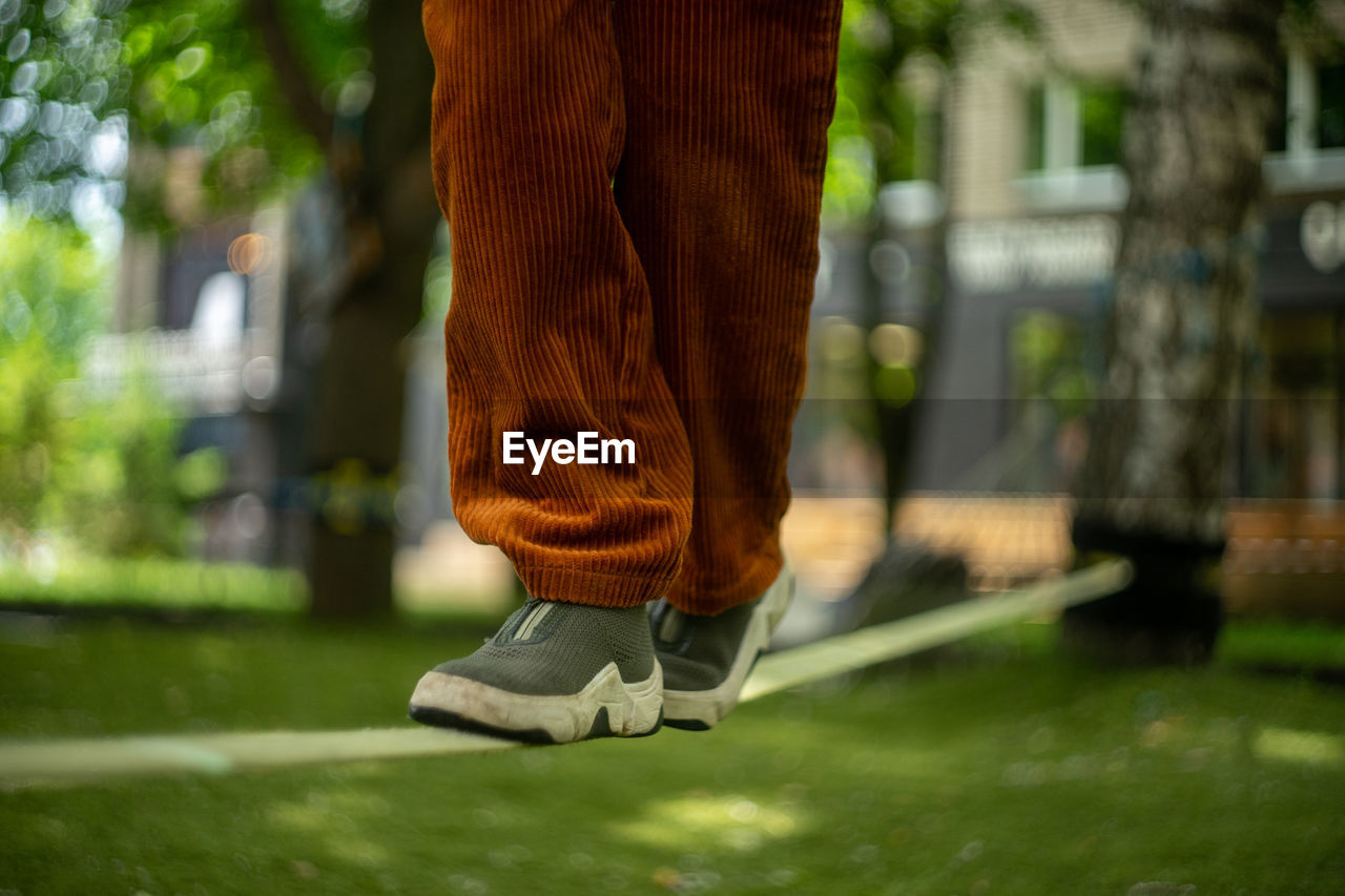 Low section of person standing in park