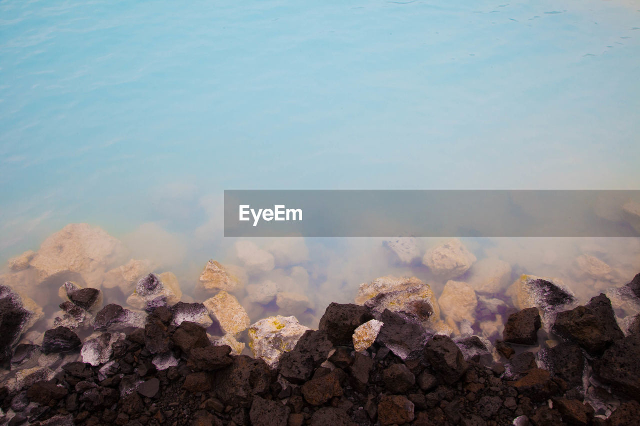 High angle view of rocks in sea