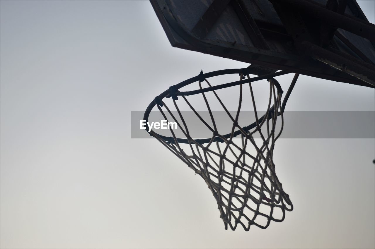 CLOSE-UP OF BASKETBALL HOOP AGAINST CLEAR SKY