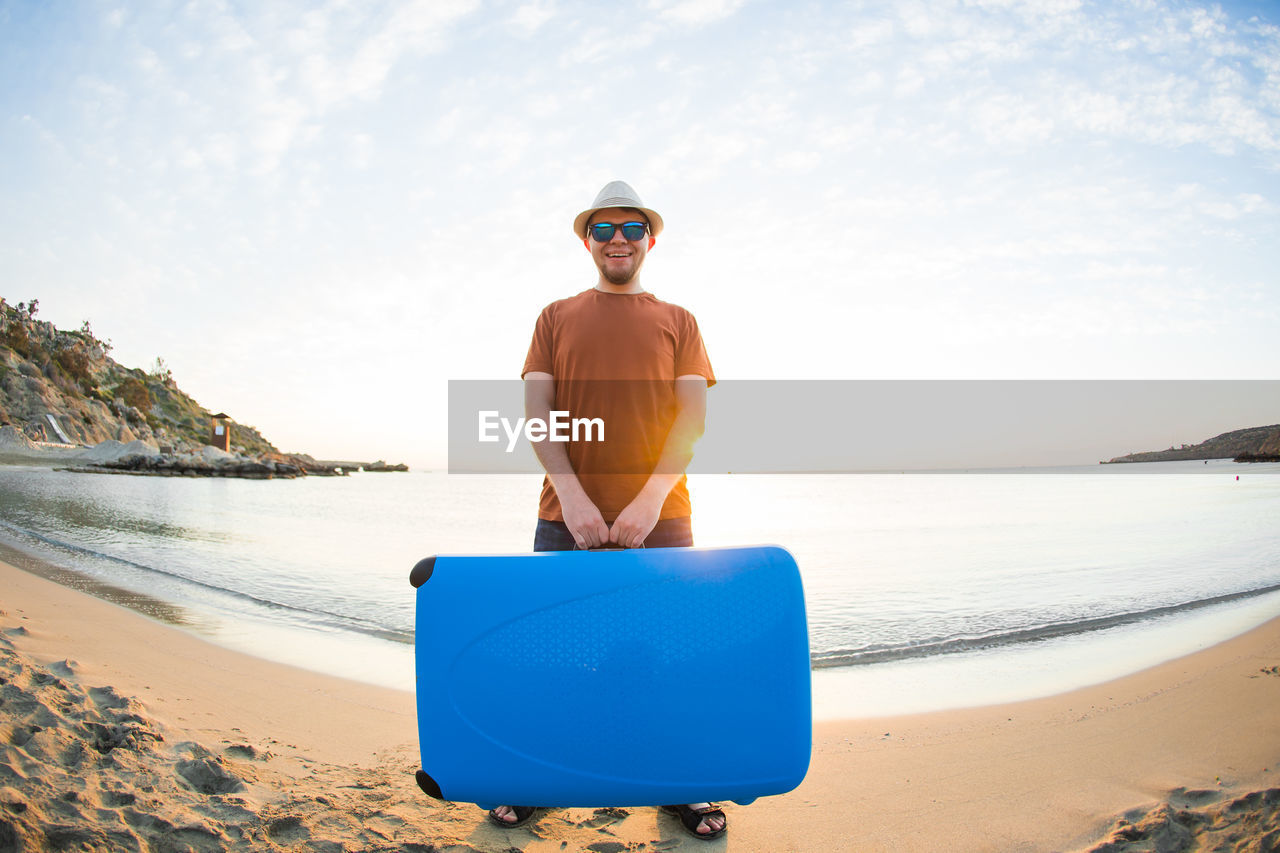 rear view of man standing at beach