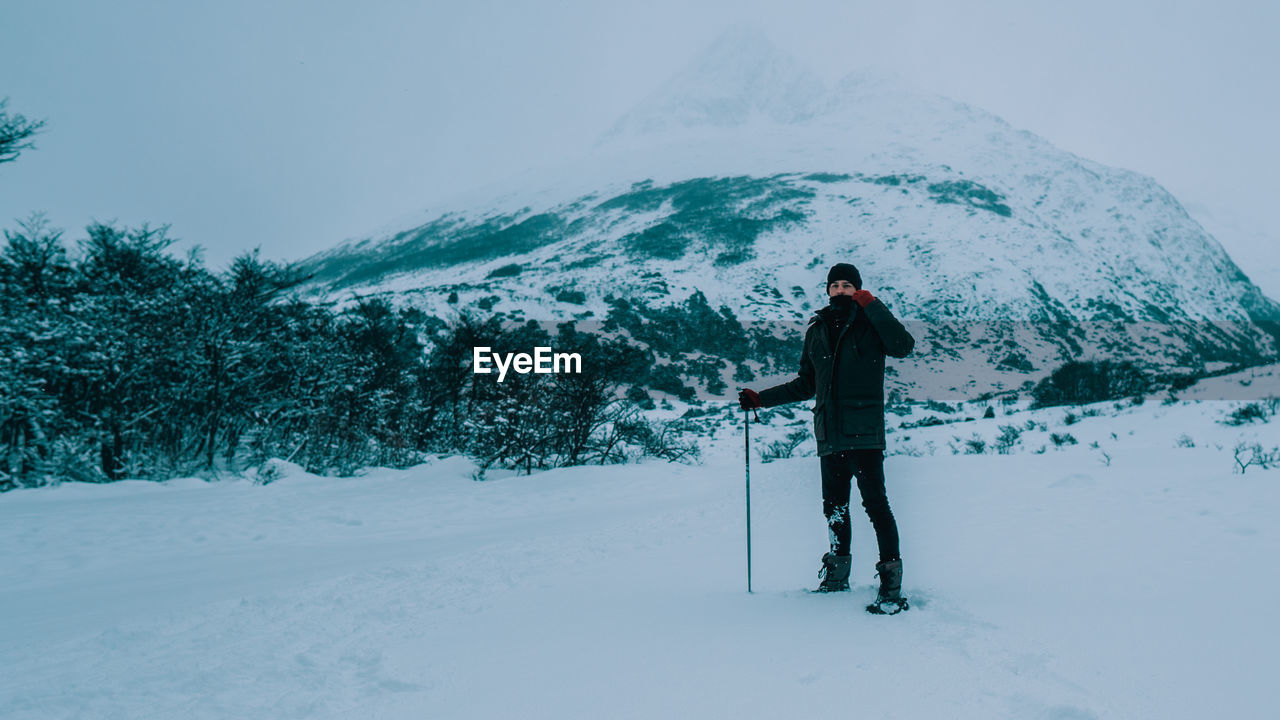 Man standing on snow covered land