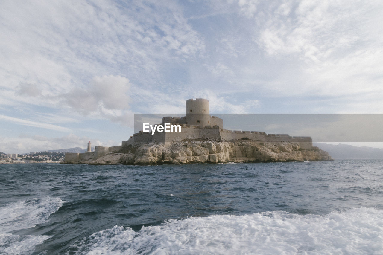 Castle by sea against sky