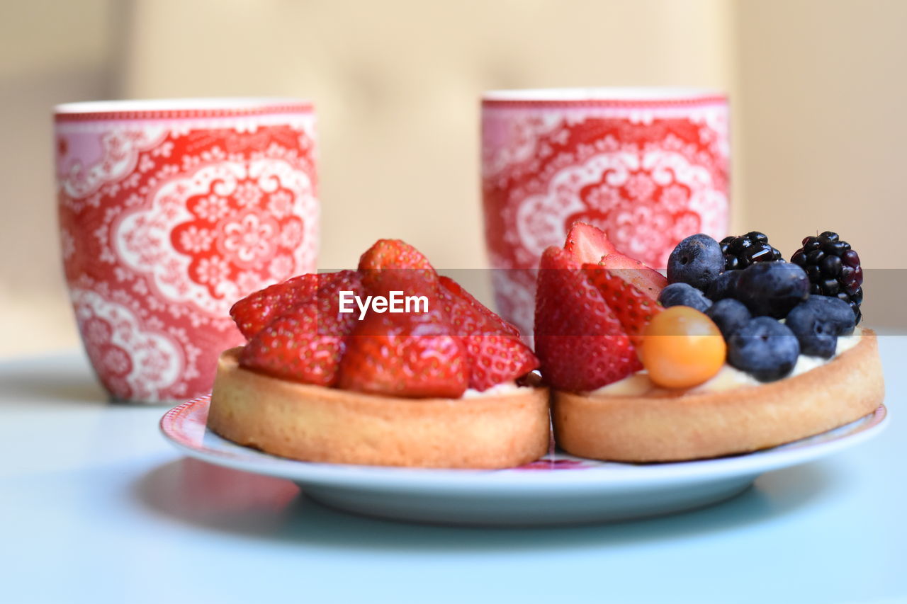 CLOSE-UP OF STRAWBERRIES ON TABLE