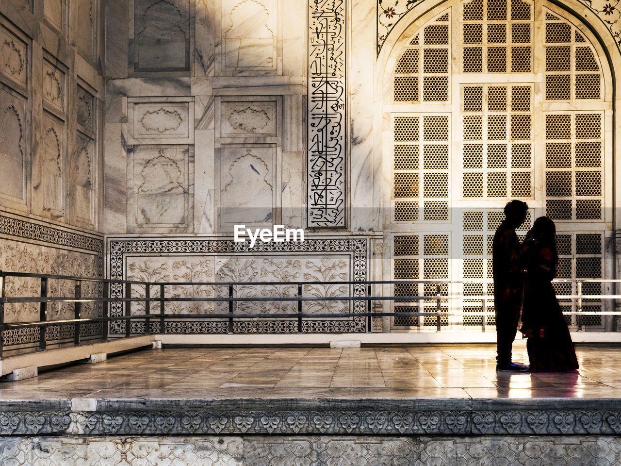 Couple standing in historic building