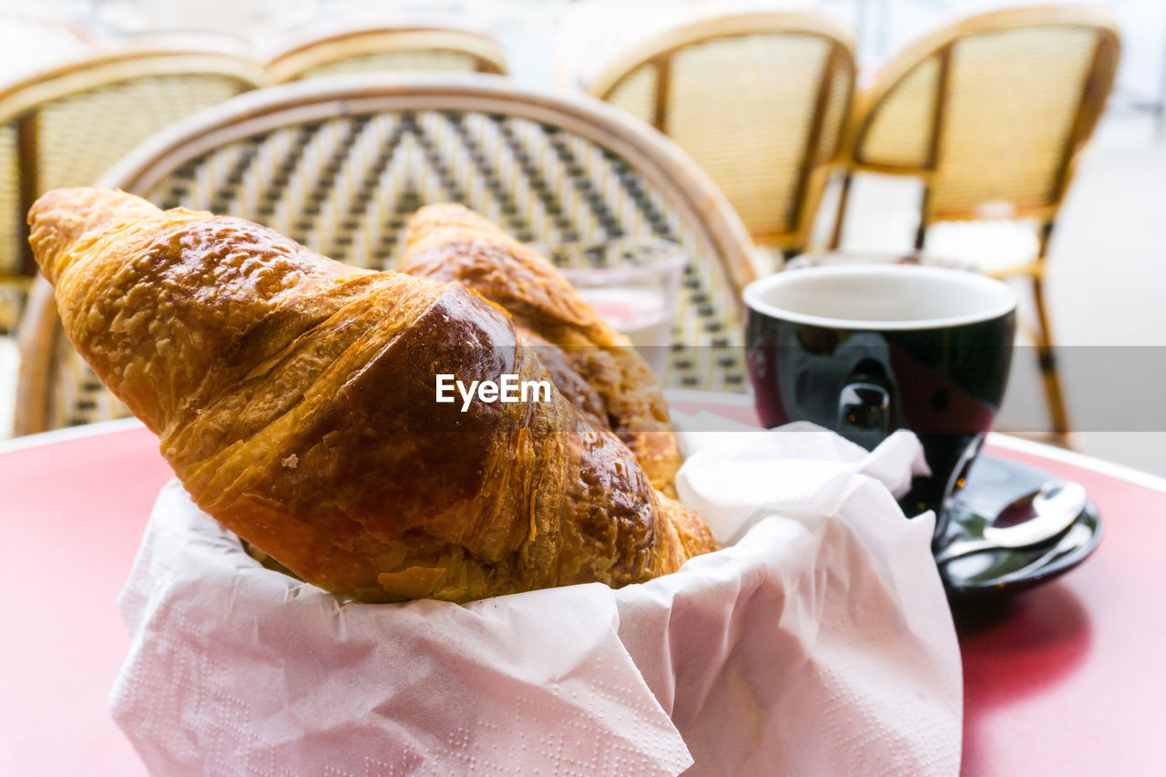 Close-up of croissants served on table at cafe