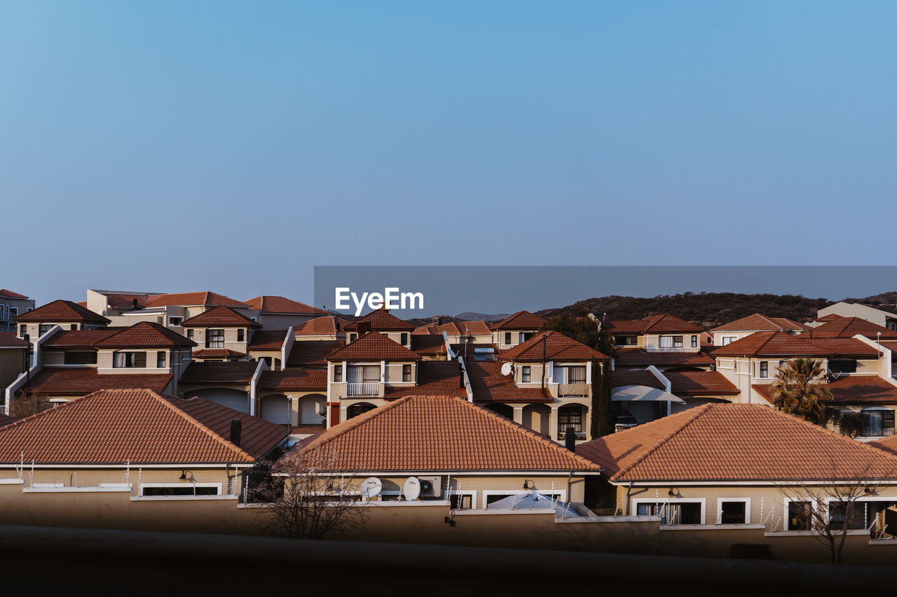 HOUSES AGAINST SKY IN CITY