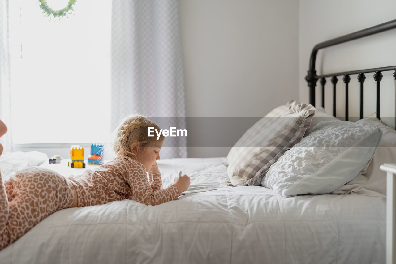 Girl lying on bed at home