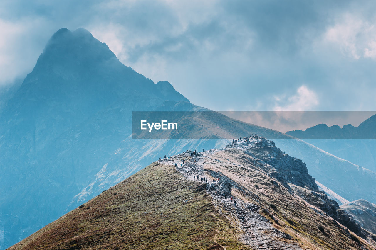 Scenic view of mountains against cloudy sky