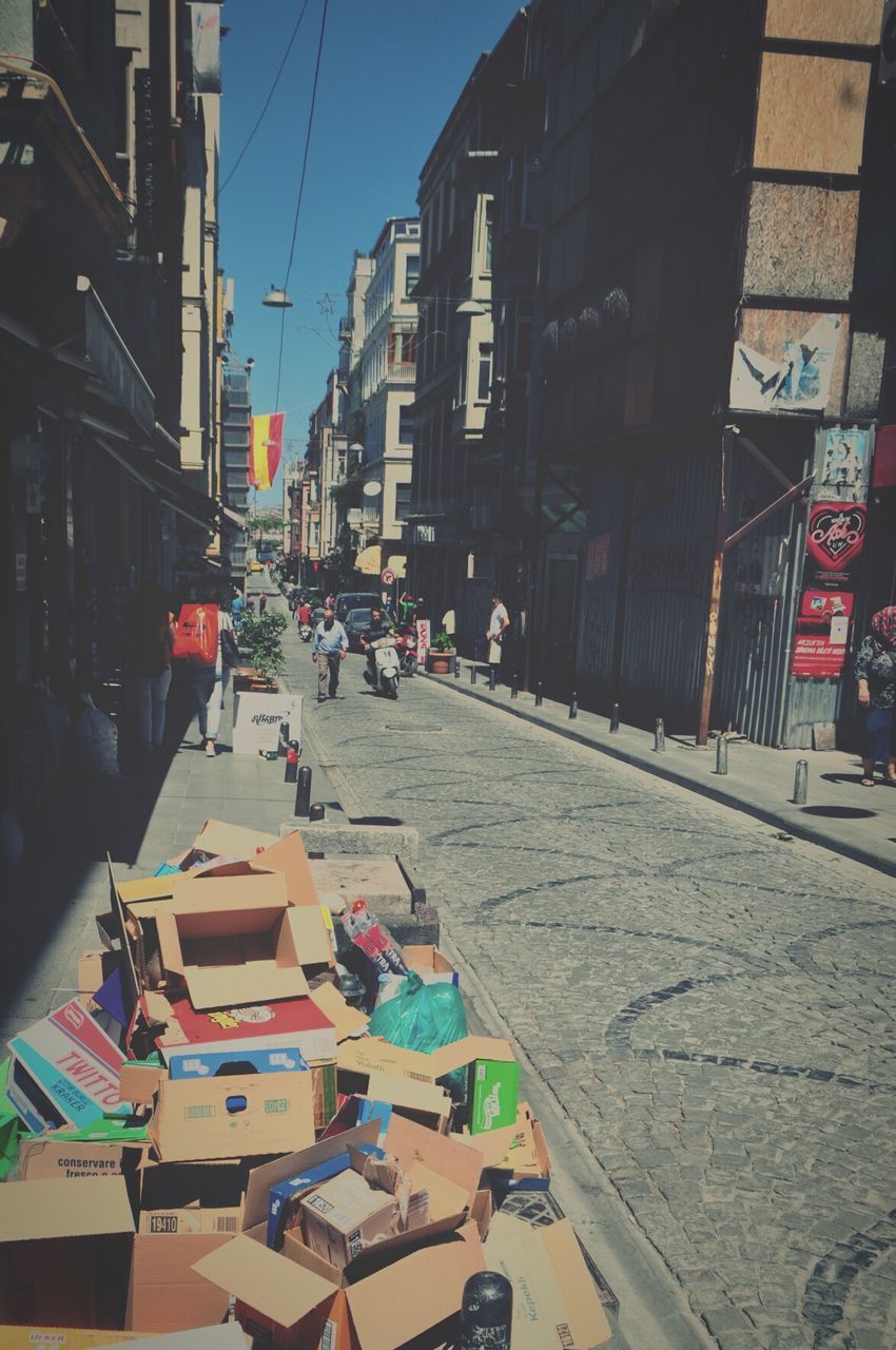 High angle view of boxes on footpath by street