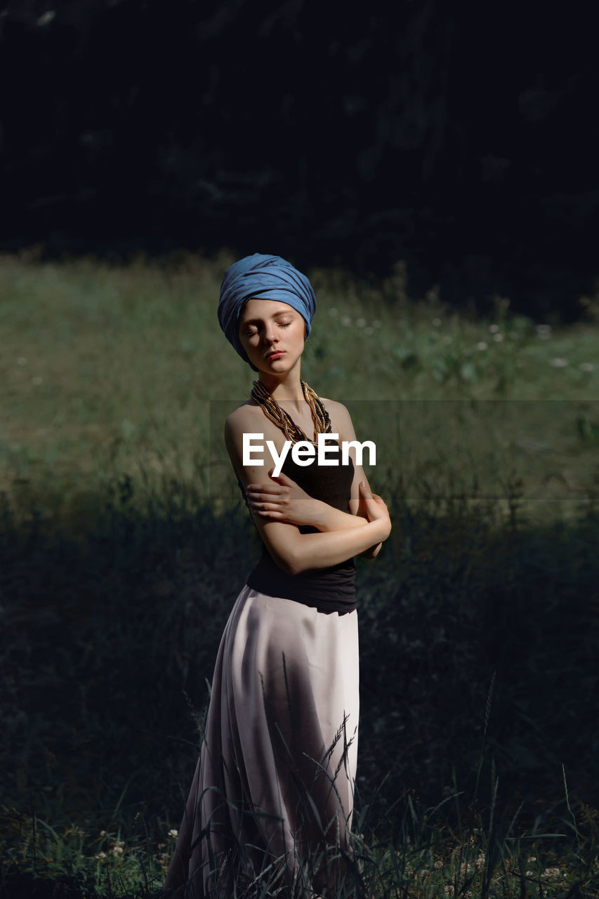 Young woman standing in grass