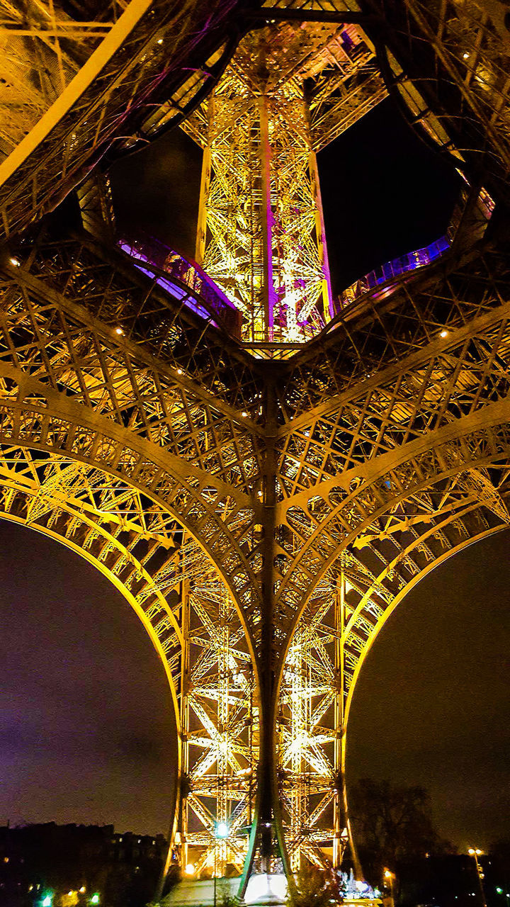 LOW ANGLE VIEW OF ILLUMINATED EIFFEL TOWER AT NIGHT