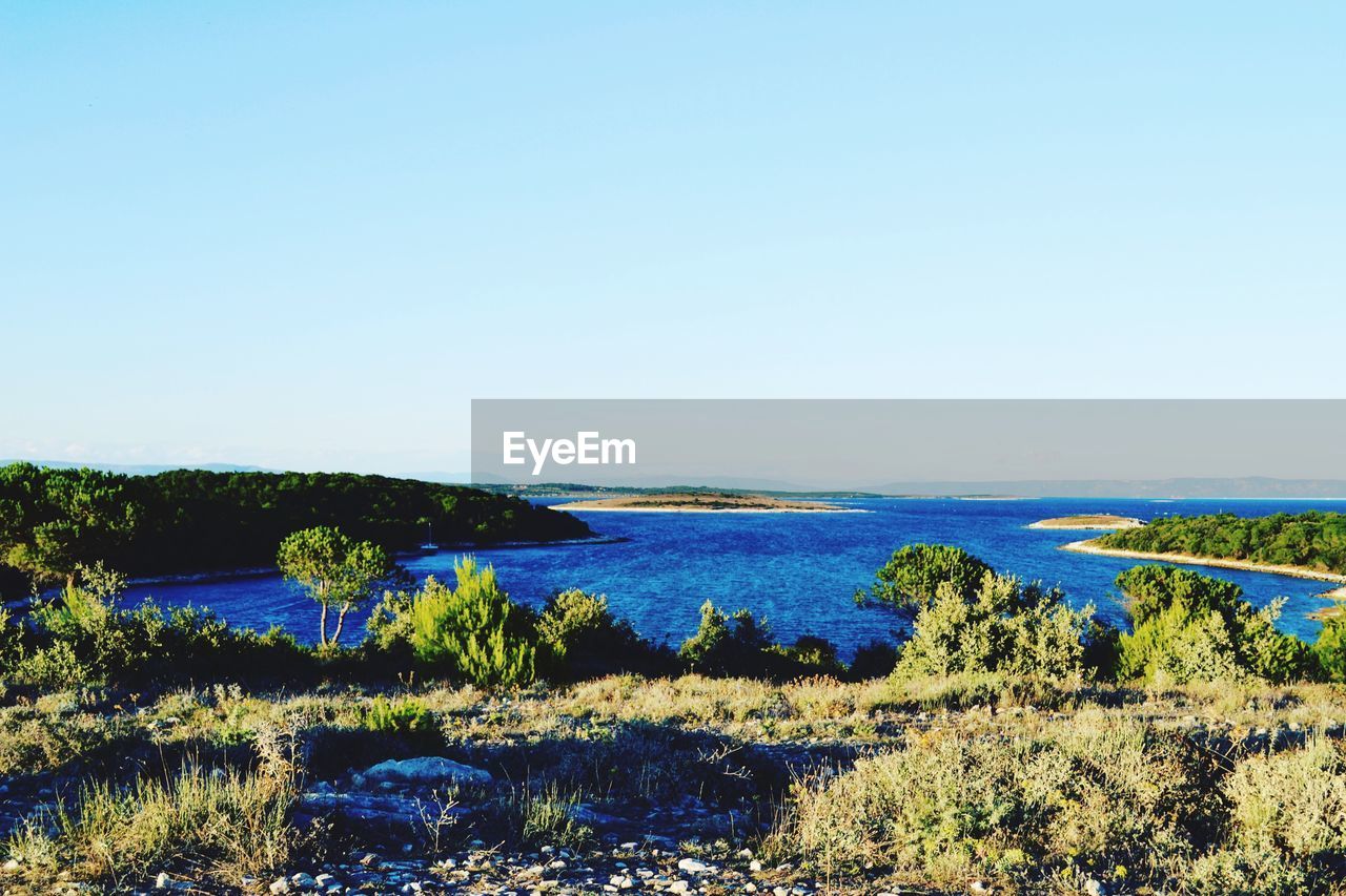 VIEW OF CALM SEA AGAINST CLEAR SKY