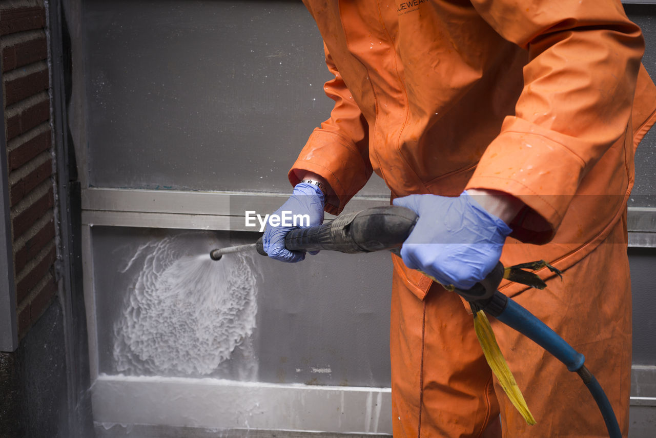 Person cleaning wall