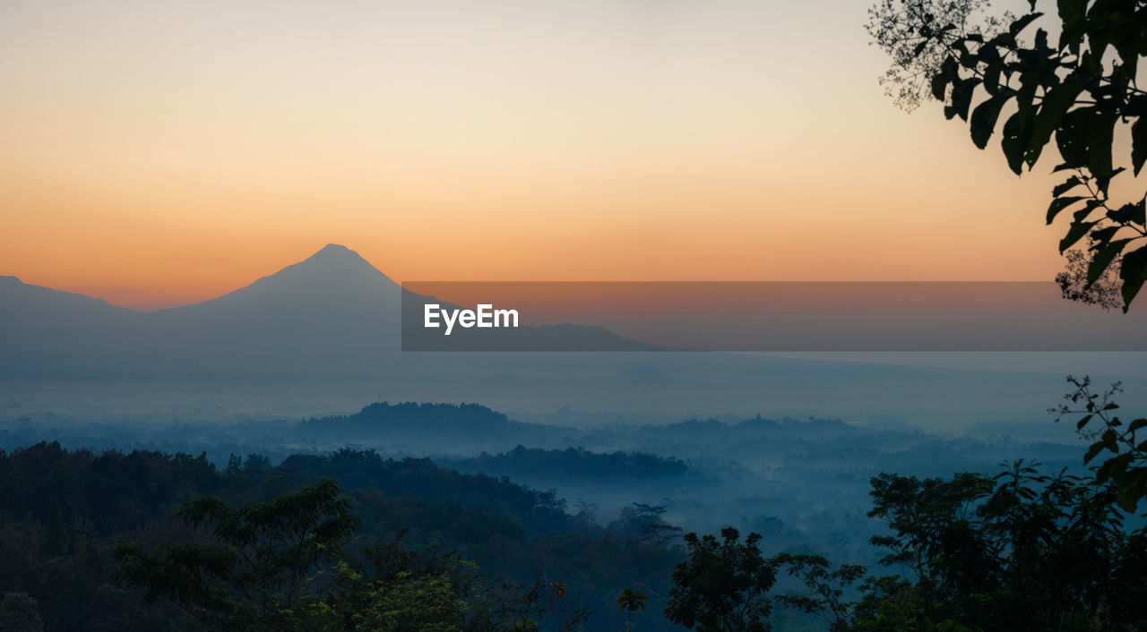 Scenic view of silhouette mountains against sky during sunset