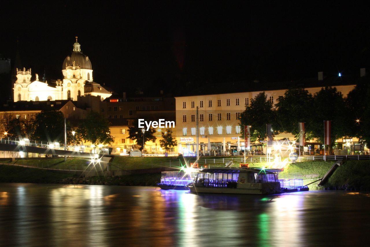 Boats sailing on river at night