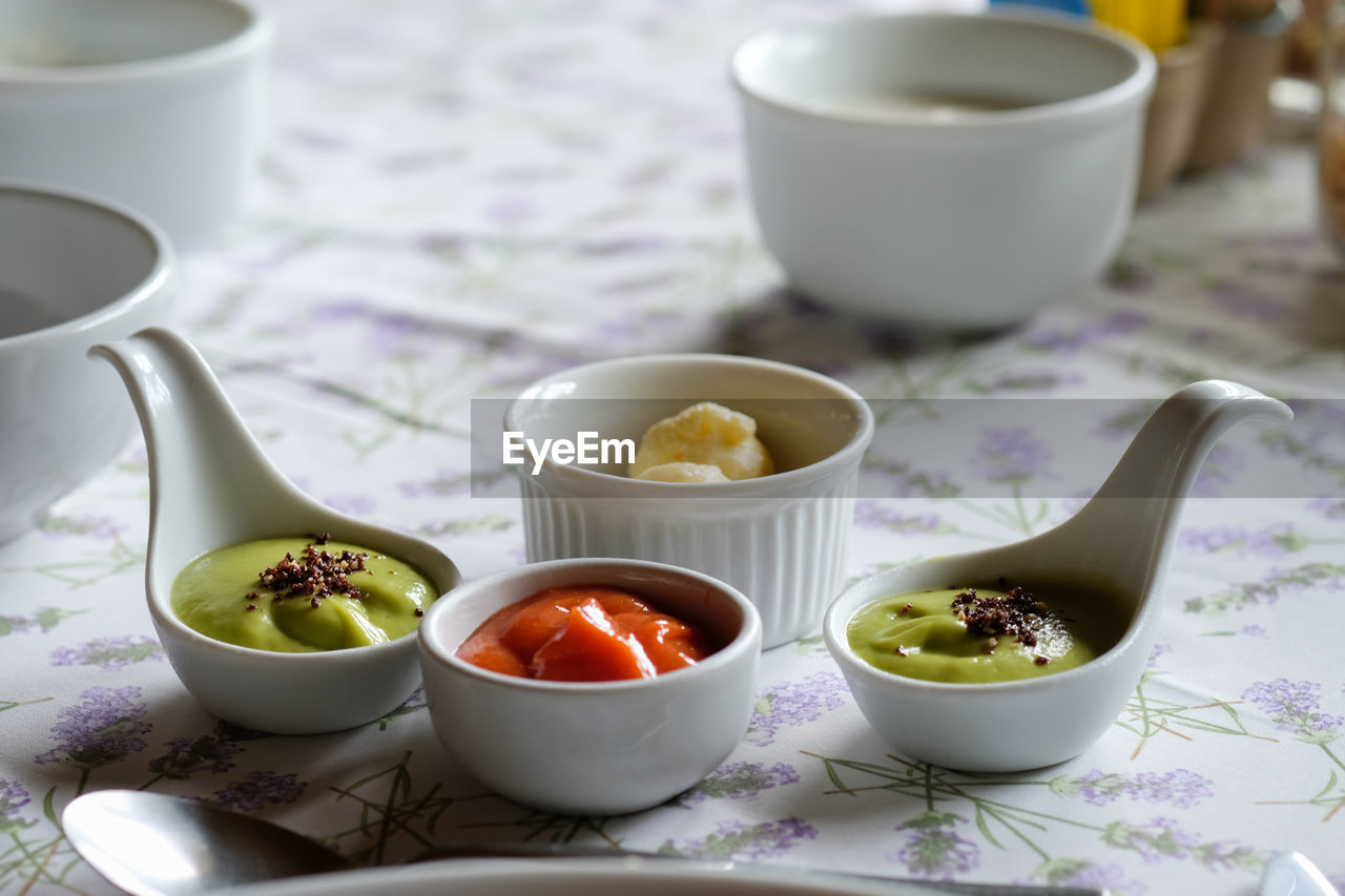 Various savory sauce in spoon on table