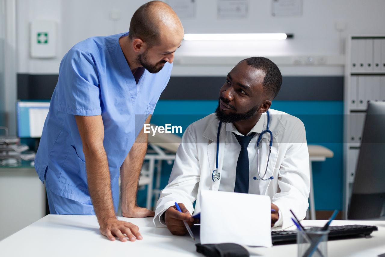 Doctor talking with patient in clinic