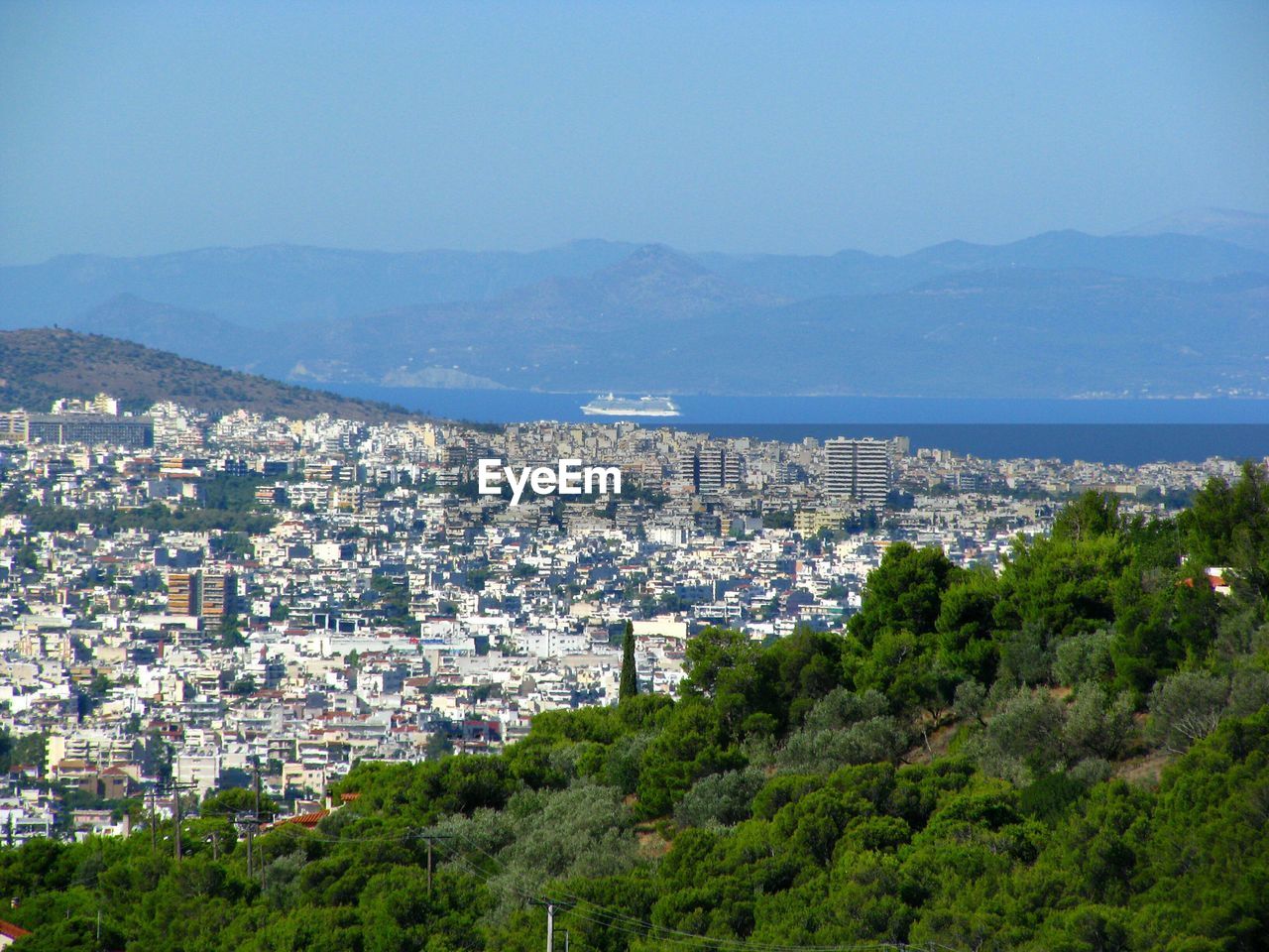 High angle view of cityscape against blue sky