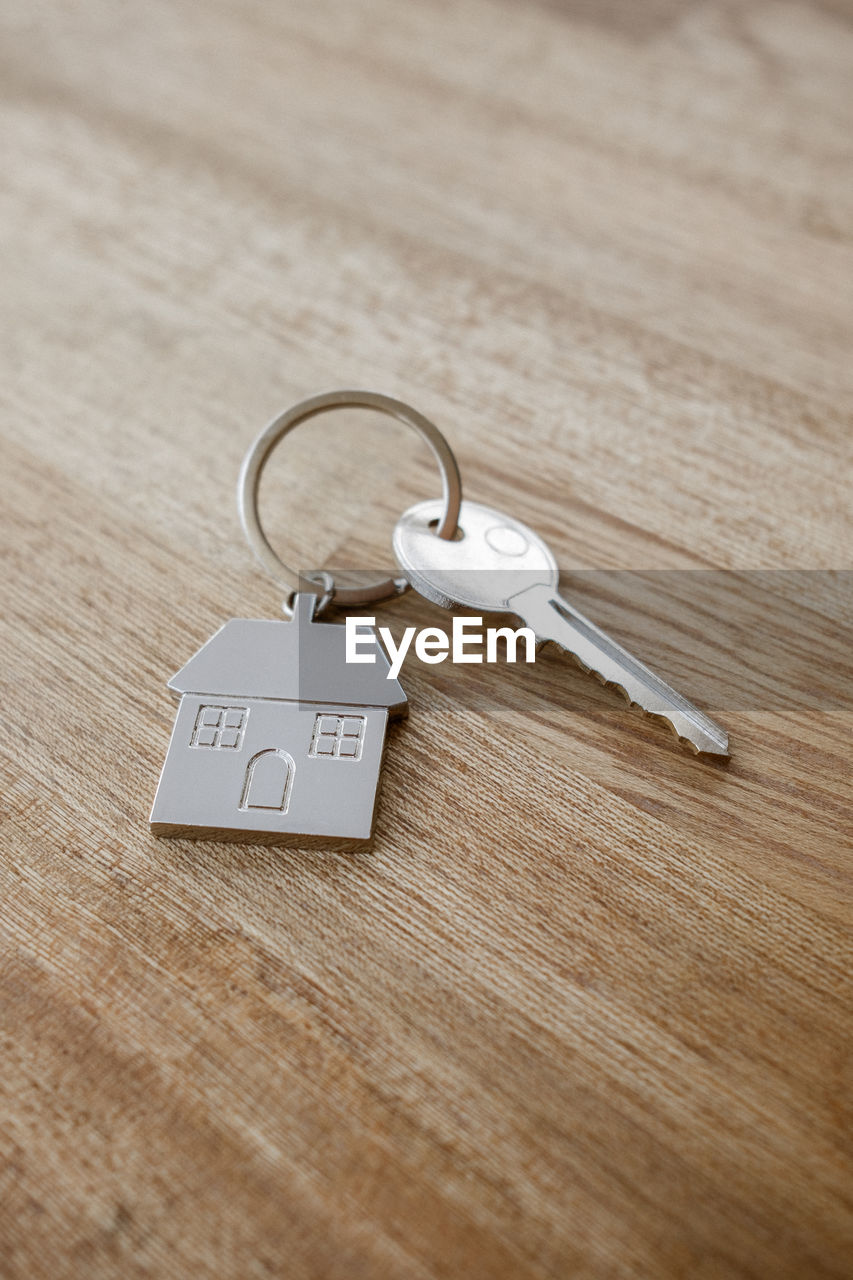 jewellery, indoors, love, wood, emotion, positive emotion, fashion accessory, no people, keychain, earring, key, white, table, copy space, communication, key ring, still life, silver, text, close-up, selective focus