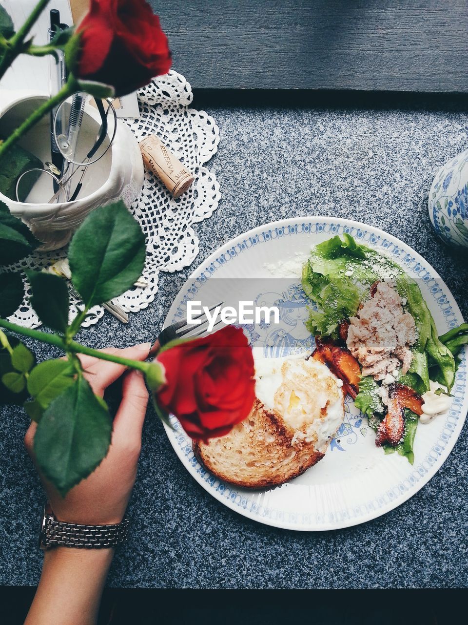 Cropped image of hand with food at restaurant