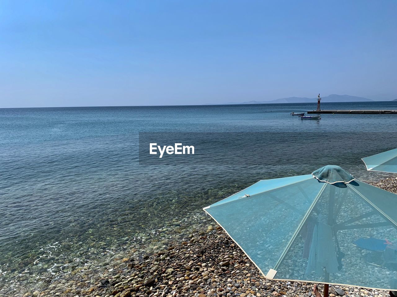 Scenic view of sea against clear blue sky