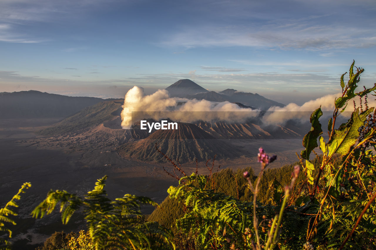 View of volcanic landscape against cloudy sky